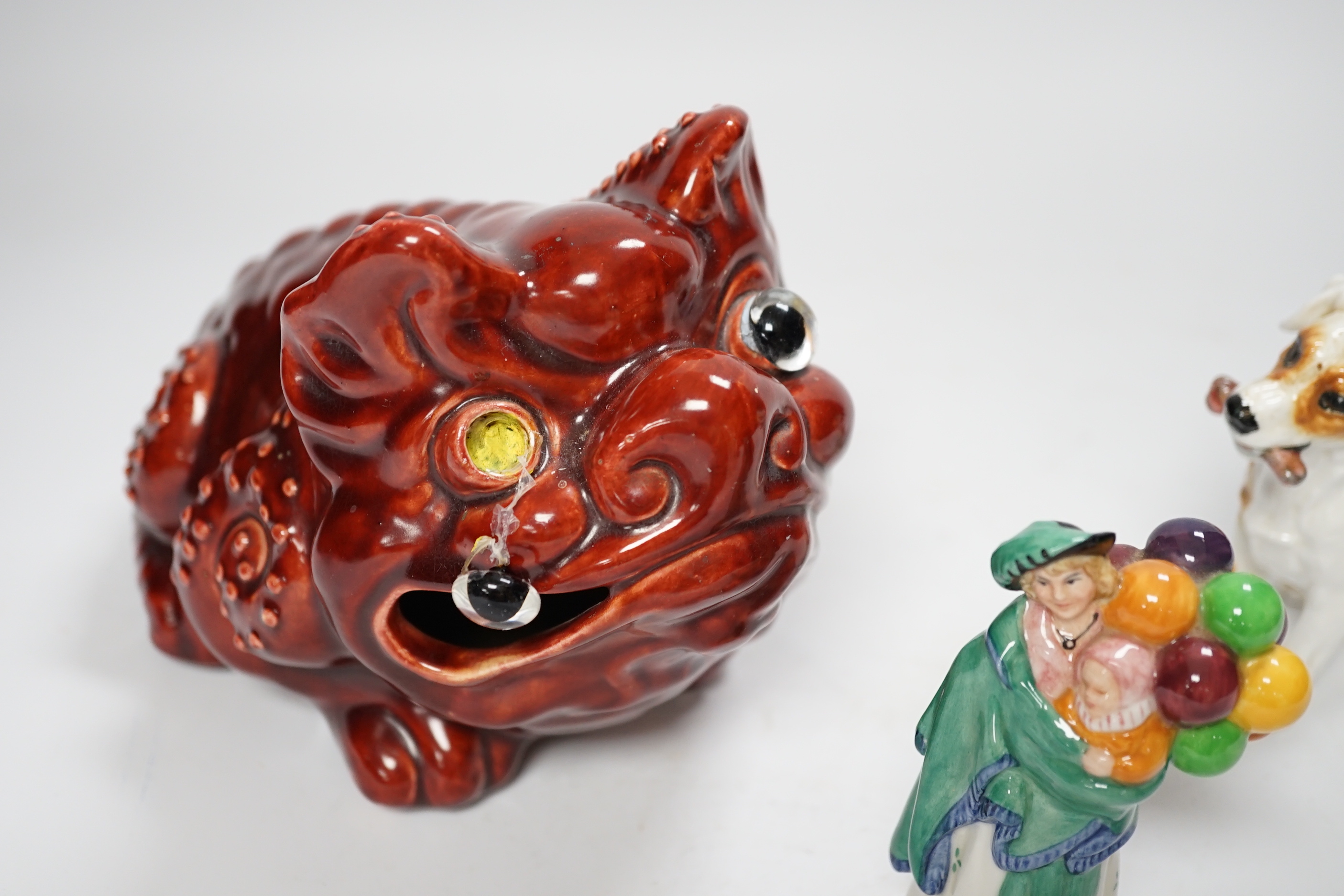 A Burmantofts style grotesque toad spoon warmer, a Royal Doulton dog ornament and The Balloon Seller, toad 18cm long